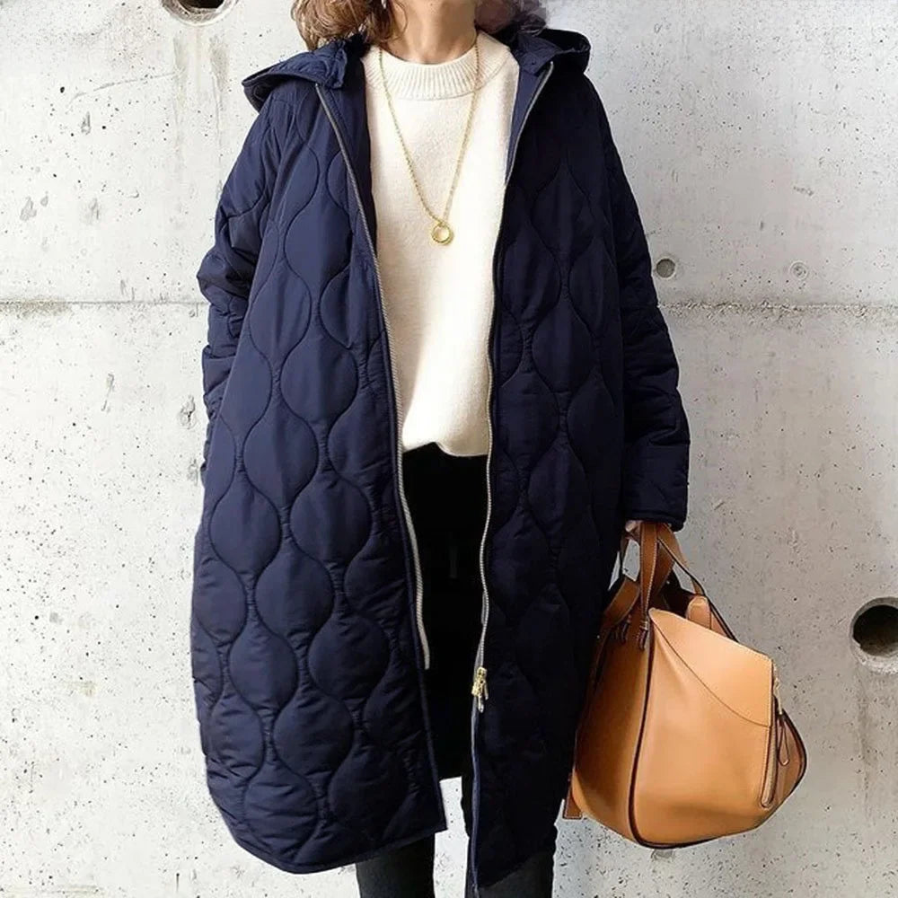 Veste matelassée pour femme avec coupe longue, capuche et fermeture éclair